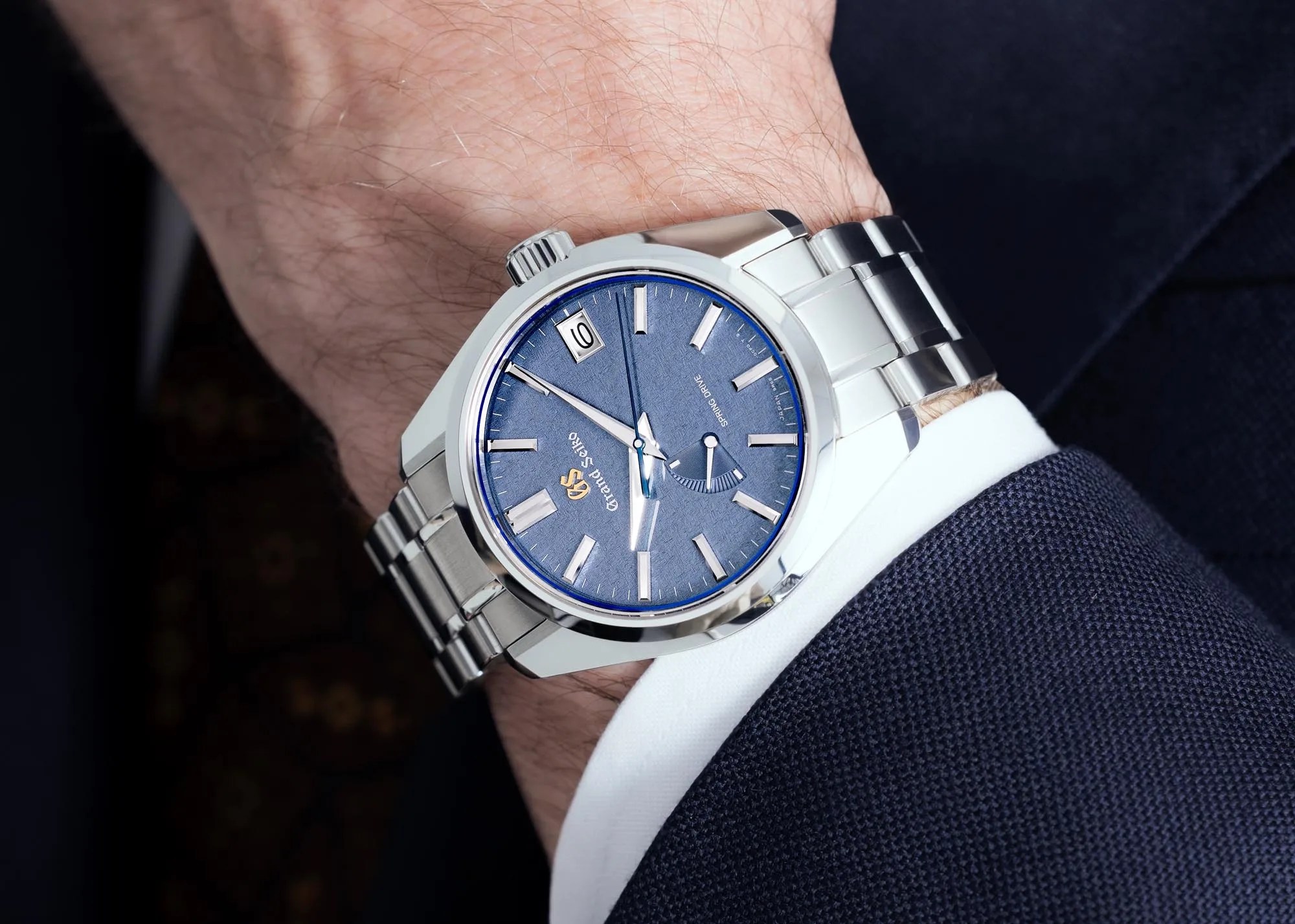 grand seiko watch worn by man in a suit